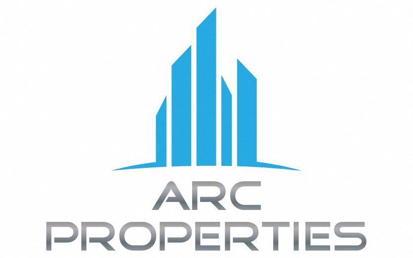 five blue towers symbolizing skyscrapers in a tight line of various heights arranged from smallest on the outsides to tallest in the center with the words ARC Properties in all capital letters with silver font under the blue towers.